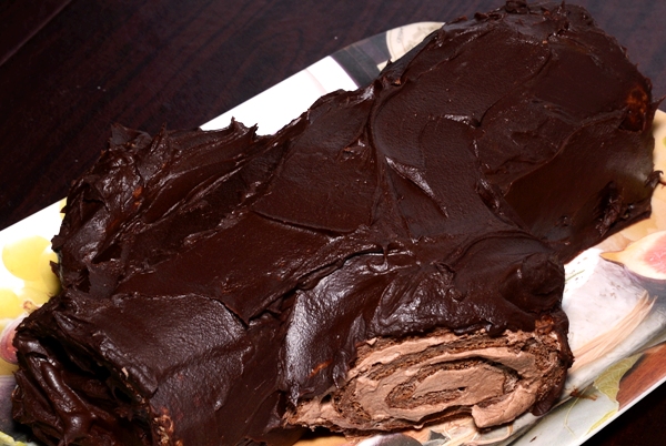 a chocolate log roll on a small platter