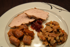 Thanksgiving dinner; roast turkey, sweet potatoes, stuffing, cranberry sauce