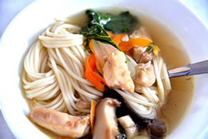 a white bowl containing Chinese Chicken Noodle Soup