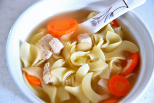 a white bowl containing Chicken Noodle Soup