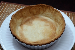 A 6 inch pie crust in a deep pie plate