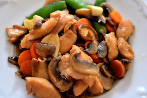 A plate of Moo Goo Gai Pan, chicken and mushrooms.