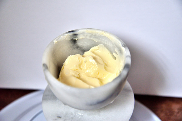 An open marble butter bell