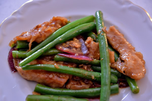 Plate containing Chinese pork and green beans