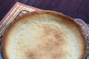 golden brown shortbread pie crust in a pie plate