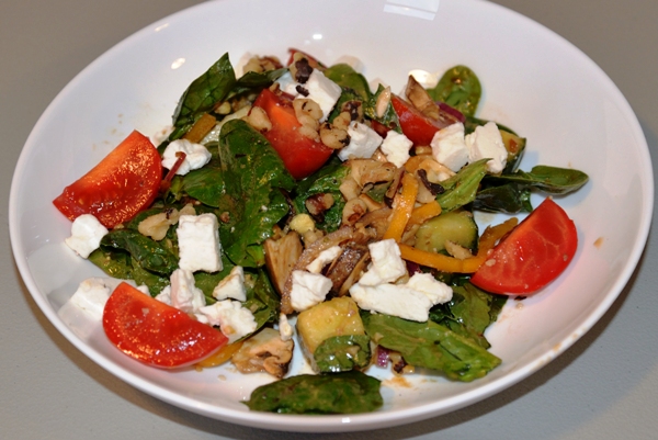 spinach salad in white bowl
